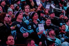 Photo of fans wearing Hockey Fights Cancer beanies and I Fight For signs provided by the Kraken and Virginia Mason Franciscan Health. 