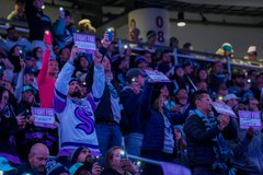 Photo of fans wearing Hockey Fights Cancer beanies and I Fight For signs provided by the Kraken and Virginia Mason Franciscan Health. 