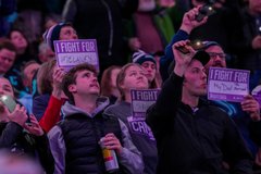 Photo of fans wearing Hockey Fights Cancer beanies and I Fight For signs provided by the Kraken and Virginia Mason Franciscan Health. 