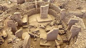 bringsnft's tweet photo. Göbekli Tepe is an archaeological site located in the southeastern part of Turkey, near the city of Şanlıurfa. It is one of the most significant and enigmatic archaeological discoveries, challenging previous assumptions about the timeline of human civilization. Here are key points about Göbekli Tepe:

Discovery:
   - Göbekli Tepe was first discovered in 1994 by German archaeologist Klaus Schmidt during a survey in the region.

Age:
   - The site is estimated to date back to the Neolithic period, with the oldest structures believed to be around 12,000 years old. This predates other ancient sites such as Stonehenge and the Egyptian pyramids.

Structures:
   - The site consists of multiple circular and oval-shaped structures, often referred to as "enclosures" or "temples." The structures are made of massive stone pillars, some of which are adorned with intricate carvings of animals and symbols.

Pillars and T-shaped Stones:
   - The pillars at Göbekli Tepe are T-shaped, with some reaching over 16 feet (5 meters) in height and weighing several tons. The T-shaped stones are arranged in circles and possibly served a ritual or symbolic purpose.

Carvings and Reliefs:
   - The pillars and stones feature elaborate carvings of animals, including wild boars, foxes, snakes, and various bird species. Some of the reliefs depict human-like figures.

Ceremonial and Ritual Significance:
   - Göbekli Tepe is widely interpreted as a ceremonial or ritual site. The presence of T-shaped pillars, carvings, and the lack of evidence for permanent habitation suggest that it may have been a place for communal gatherings and rituals.

Agricultural Connection:
   - The site challenges previous theories that agriculture led to the development of complex societies. Göbekli Tepe predates the advent of agriculture in the region, suggesting that complex social and religious activities may have driven the transition to settled life.

Burials:
   - Some evidence of burial practices has been found at Göbekli Tepe, including the presence of human remains beneath some of the pillars.

World Heritage Site:
   - Göbekli Tepe was designated a UNESCO World Heritage Site in 2018, recognizing its cultural significance and the insights it provides into early human history.

Göbekli Tepe has sparked considerable interest and debate among archaeologists, anthropologists, and historians. It has reshaped our understanding of the capacities of ancient societies and the evolution of complex human culture.