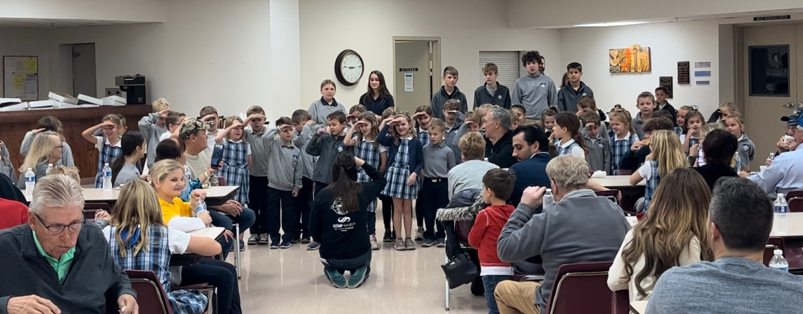 QASSchool's tweet photo. NJHS students honor veterans today with a special mass and reception. First graders sang a patriotic song for them!🇺🇸 https://t.co/p6SdNZ8L7y