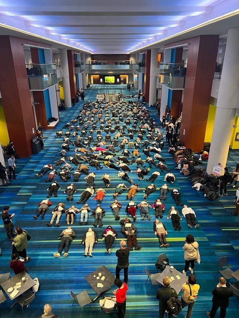 A die-in at <a href="/AmericanAnthro/">American Anthropological Association</a>, each person holding a name of a child killed by Israeli assault on Gaza.
