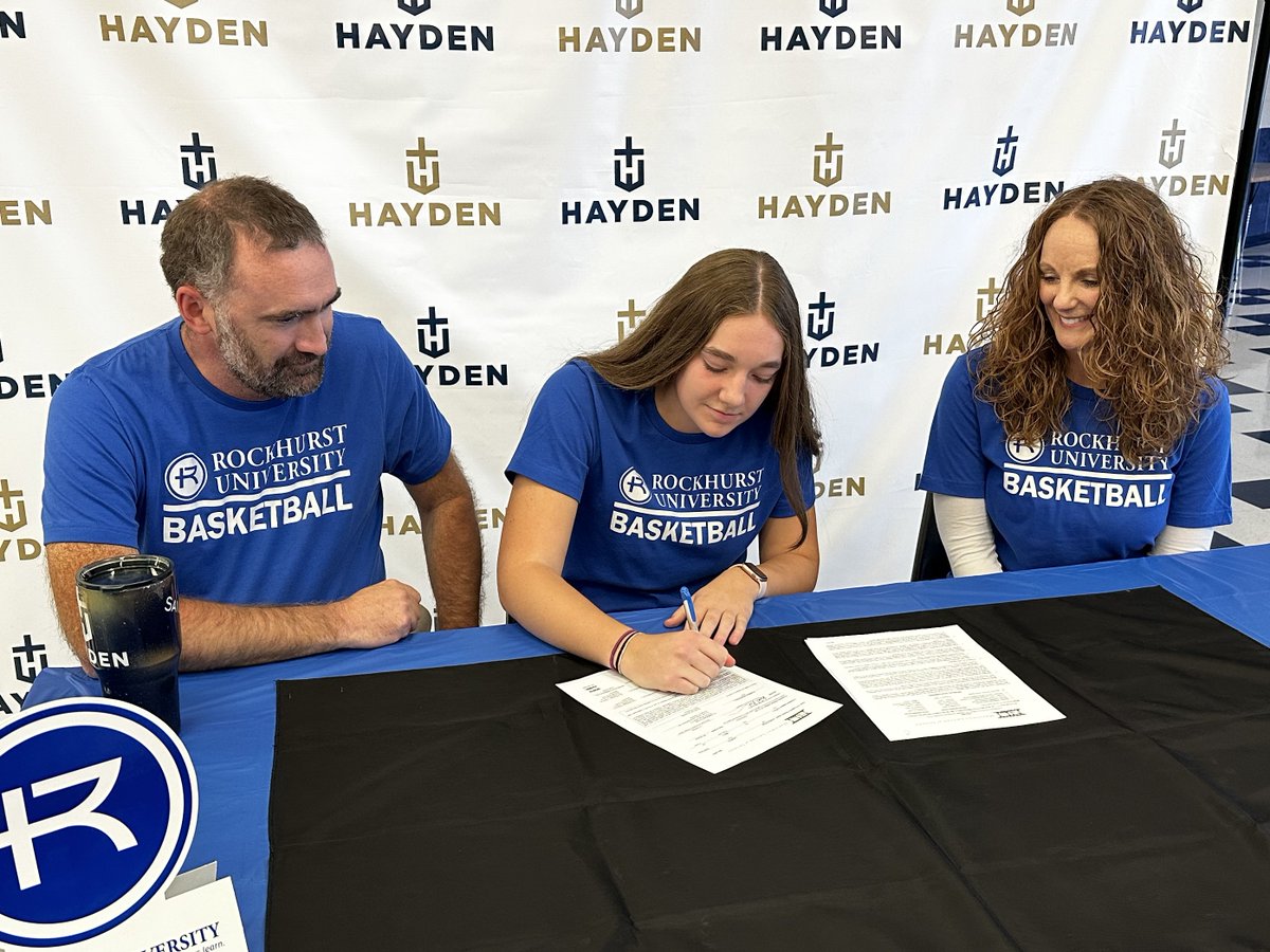 . <a href="/HaydenHigh/">Hayden Catholic HS</a> multisport standout <a href="/LaurenSandstr0m/">Lauren Sandstrom</a>, flanked by her parents, James and Stacey, signs her letter of intent with <a href="/RUhawks/">Rockhurst Athletics</a> for women's basketball Friday at Hayden.  <a href="/HaydenGirlsBbal/">Hayden Girls Basketball</a>