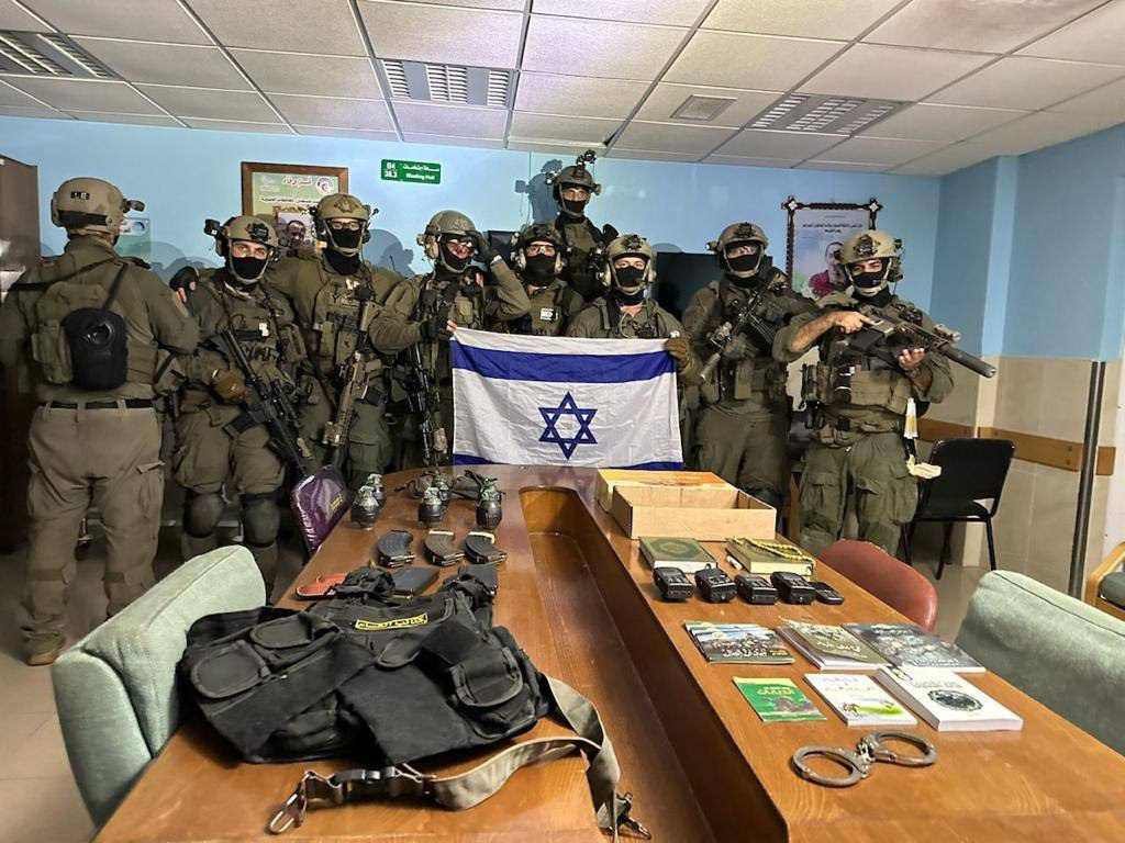 QudsNen's tweet photo. Israeli occupation soldiers celebrate their "victory" inside the Al Shifa Hospital in Gaza. https://t.co/bgy9uu49Hq
