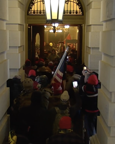 capitolresearc3's tweet photo. 2:18 PM #BumbleGoggles arrives (also from the group that walked around from the West, he's with the flag here, probably #VirginiaSnap next to him). He can't get in, and heads out to the NE Courtyard where he'll start waving his flag. 5/ https://t.co/2a2UvnOGLt