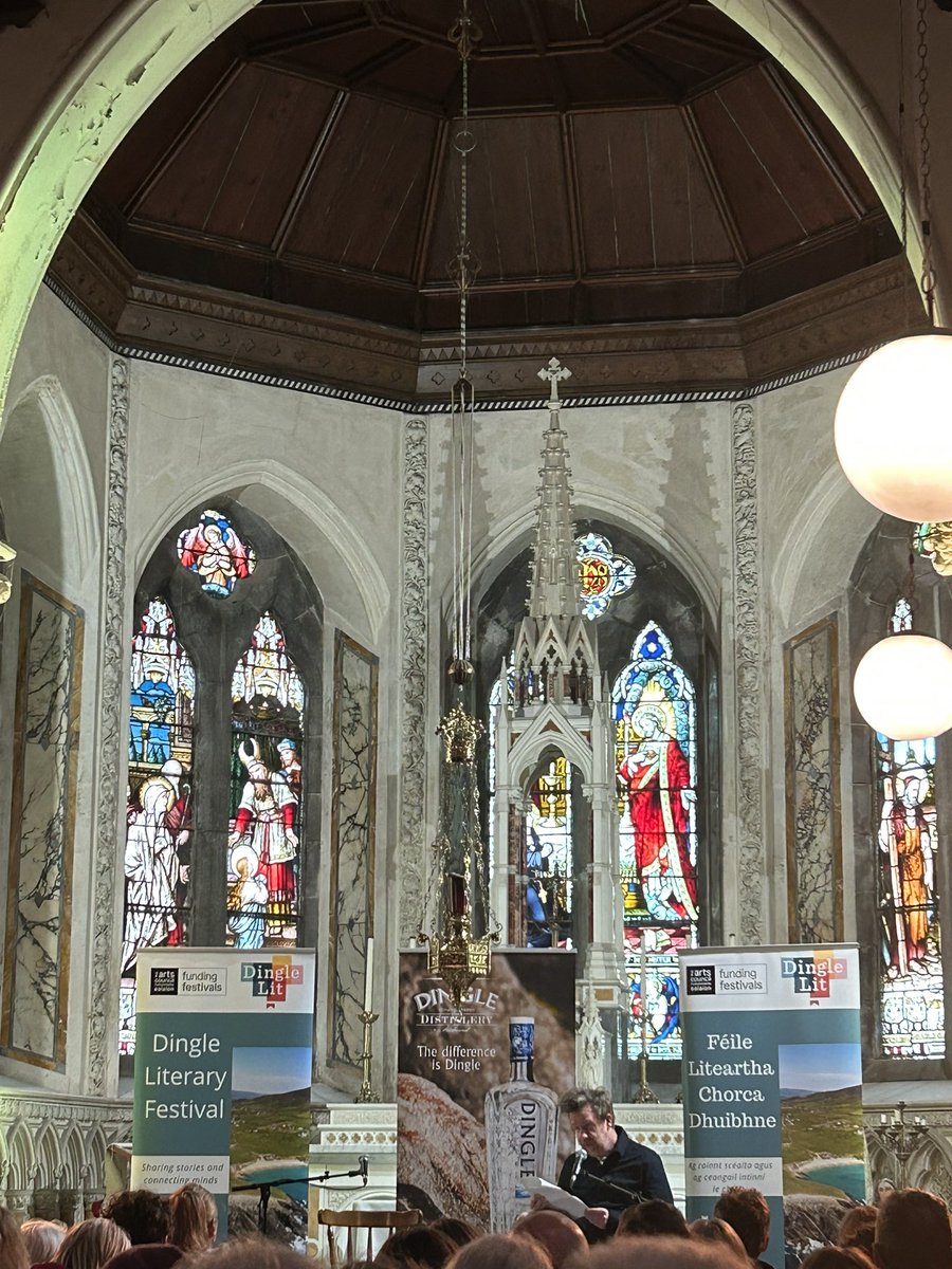 The inimitable Kevin Barry reading from his new work surrounded by Harry Clarke windows @DingleLit 🫶🏽