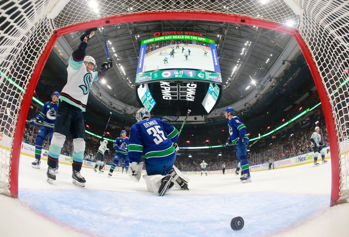 goal cam picture from inside the canucks net. puck is going into the net and ebs is celebrating in front of the net