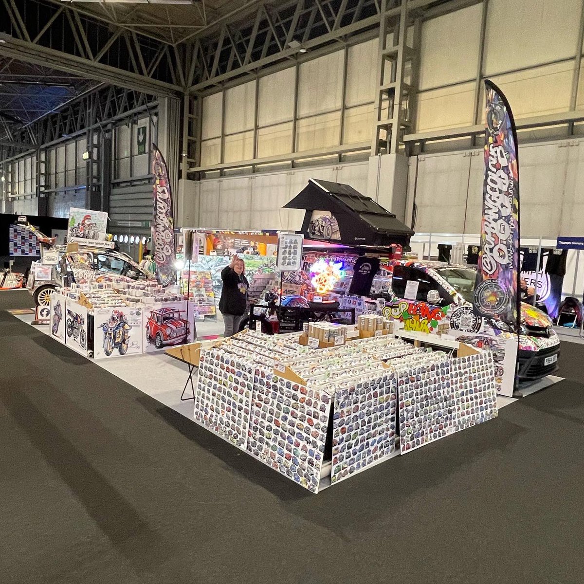 Popbangcolour's tweet photo. Day 2 of @motorcyclelive is go! Come say hi in hall 3 where you’ll find Mother Cook &amp; I 

The @asecustommc is lit up by the POPBANGCOLOUR missionneonsigns with the Latitude Tents on top of the van. 

The @GarageStyleLtd flooring adding some colour to the stand too #MotorcycleLive https://t.co/BH3D6hKMxu