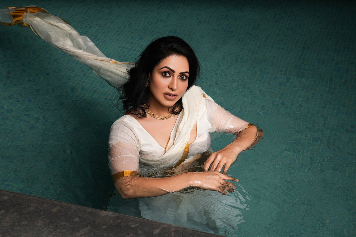 'Drenched in Elegance: Embracing the allure of a wet saree look. #SareeStyle #IndianElegance #GracefulCharm