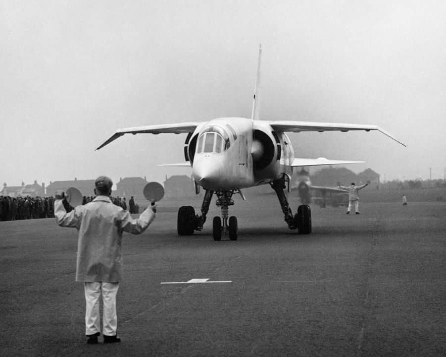 Back from one of its (often rather fraught) early test flights, the prototype BAC TSR-2, with the Lightning chase aircraft behind, is marshalled back to its parking spot in the Autumn on 1964. A 'valve era' electronic suite didn't help its case to survive the 'axe' IMHO.