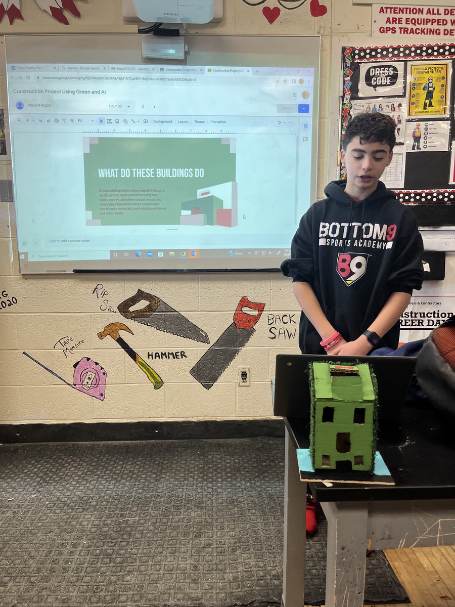 Carter Ruggiero and Vincent Nuzzo shown here in technology education presenting there construction project.  Students had created a new or remodeled building with green technology and Artificial Intelligence.