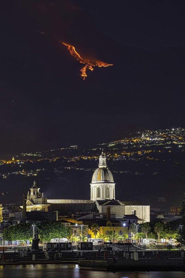Eruption on Mount Etna (Sicily) creates the illusion of a Phoenix in the sky.