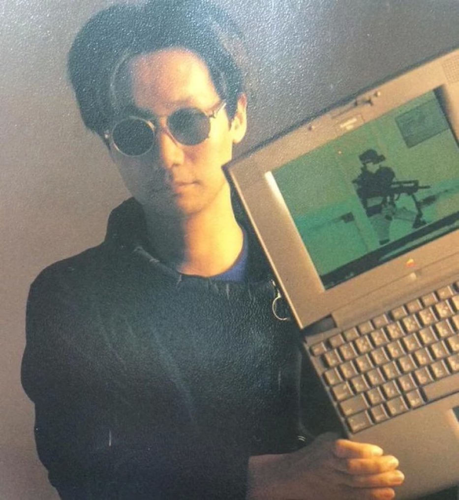 Young Hideo Kojima with a apple laptop running MGS