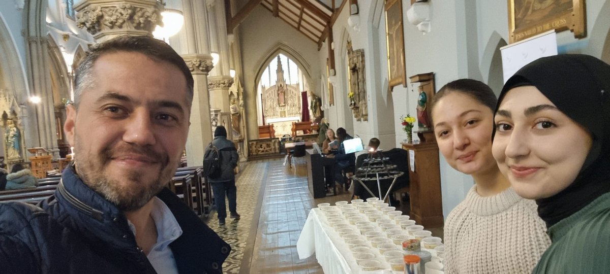 DialogueSociety's tweet photo. At the St. Vincent De Paul Roman Catholic Church, Liverpool Dialogue Society volunteers distributed 'aşure' during Interfaith Week. İpek, our volunteer, underscored the importance of diverse communities coming together. Symbolising the unity✨ #NoahsPudding #InterFaithWeek https://t.co/SlQ39IZXO7