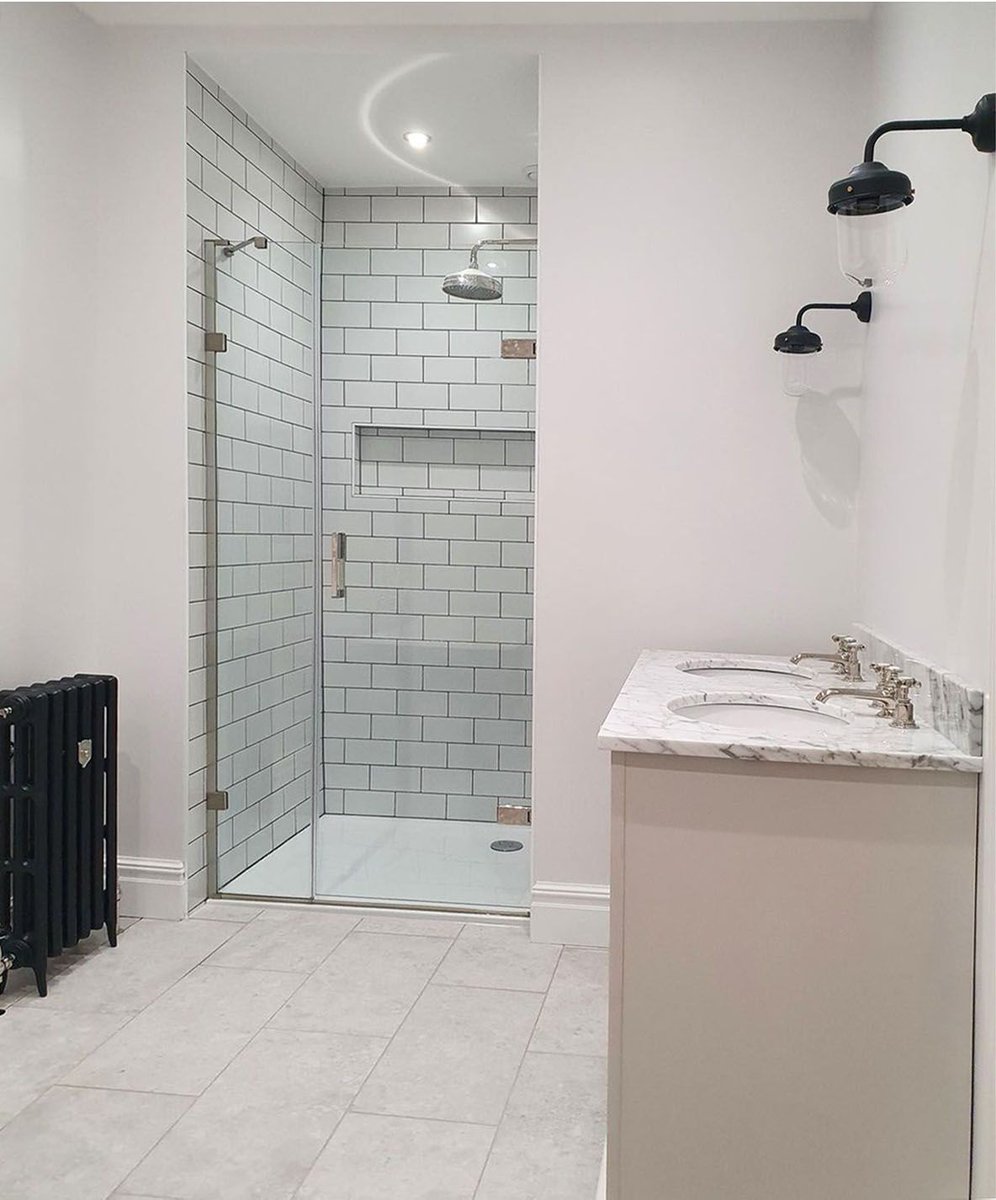 Minimalist bathrooms are functional, precise and often stark. The neat and uncluttered style is achieved by eliminating most of the decor or using functional items to double as decor. Bathroom credit goes to @endinteriors Liberty Hinged Door | buff.ly/3qbzjym