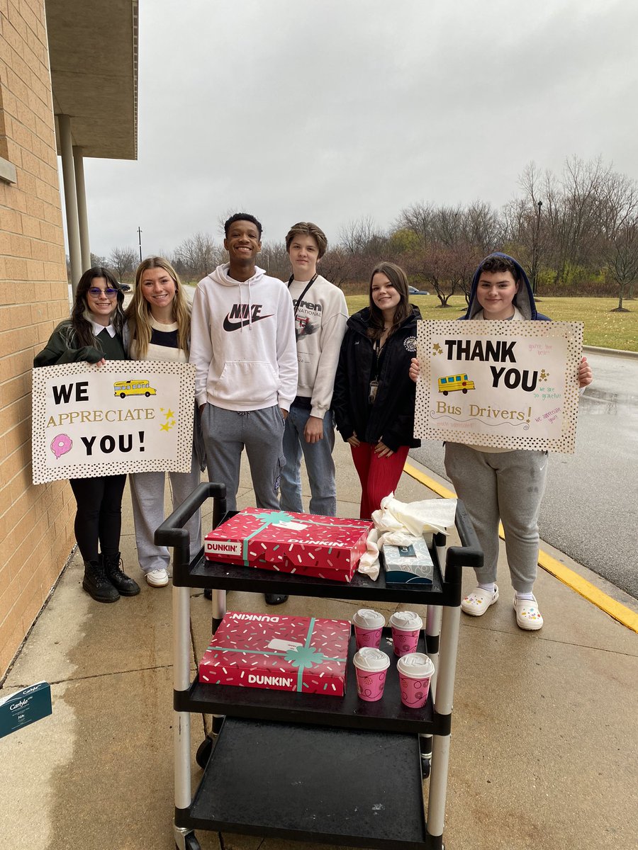 GNHSActivities's tweet photo. The rain didn’t stop us from thanking our much deserving BUS DRIVERS this morning!!! ☕️ 🍩 Happy Thanksgiving to all! @J_Renaissance @Dwight_Carter @GNKnightsMedia @GrayslakeNorth @Jostens #StandUp #NovemberCultureChallenge #CurbsideCoffee https://t.co/t1raljpbNF