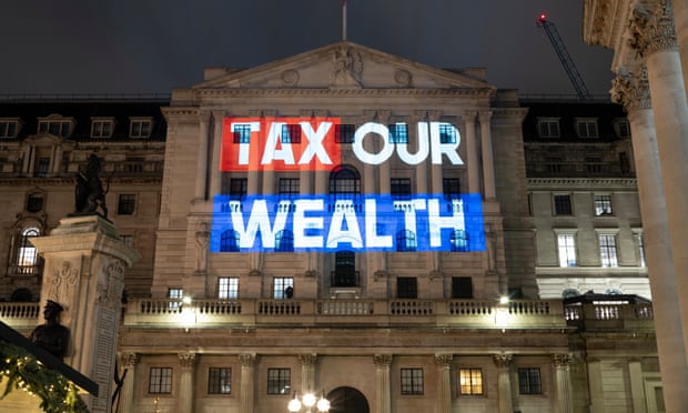 A group of UK millionaires have projected a message on to the Treasury building and the Bank of England which says: “Tax our wealth” A 2% tax on those with more than £10 million could raise £22 billion a year, enough to pay for the average salary cost of more than 600,000 nurses