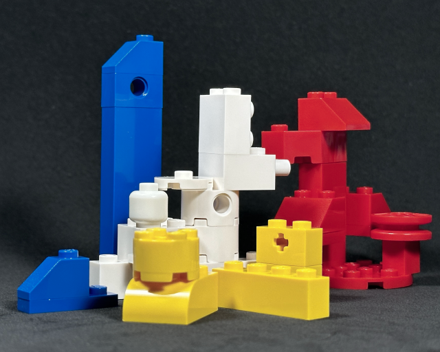 LandscapeArtBot's tweet photo. new dining room art. still life, red, yellow, white, blue lego on a black foam sheet #art #stilllife #stablediffusion https://t.co/modJ1nN0gi
