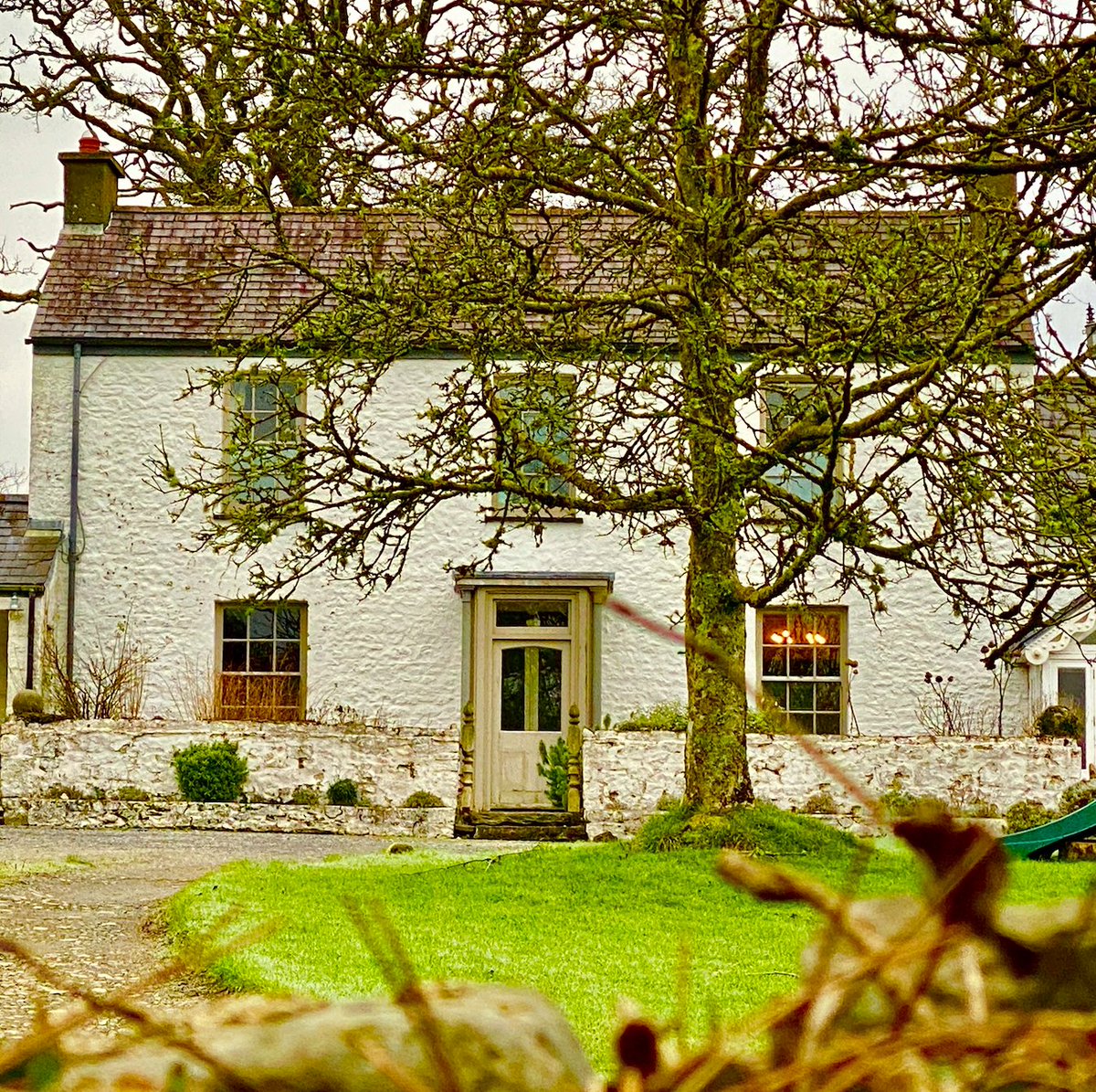 A cosy Victorian farmhouse in Carmarthenshire. Whitewashed external walls are typical of rural Wales. Whitewash is made from crushed and heated limestone. It was one of the cheapest ways to paint a cottage - historically available to the poorest of cottage dwellers.