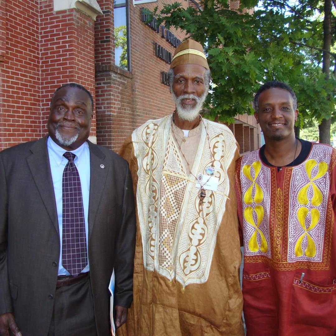 AfricanaCarr's tweet photo. From Mwariama Kamau, UNIA Historian: “It is with heavy heart that I must notify you of transition of UNIA High Commissioner Baba Oduno A. Tarik…All Universal African Flags should fly half-mast for 40 days following his funeral.”(Baba Oduno (c) with James Donaldson &amp; me). Asé-00! https://t.co/kUeOPC10ub
