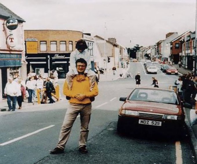 This photograph was taken seconds before the red car explodes, killing 29 people including the photographer. The camera was found afterwards in the rubble. The man and child in the photo both survived.

The Omagh bombing was a car bombing on 15 August 1998 in the town of Omagh in