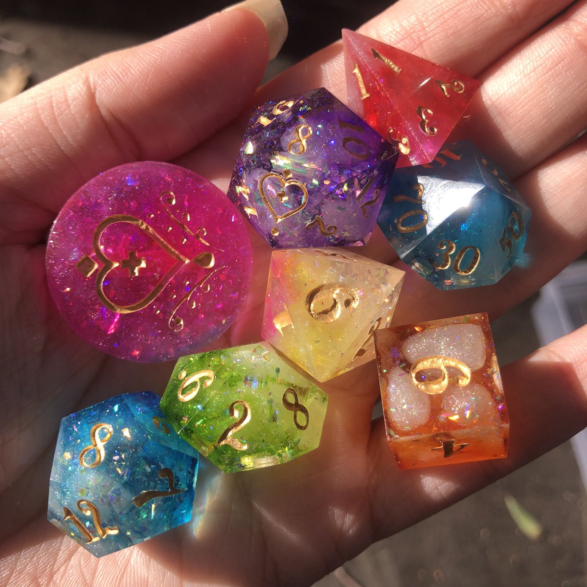 HealersHug's tweet image. Rainbow Road dice set ready for the shop update today at 4pm PT. Wanted to show these off in the sunlight but its so hard to film with only one hand. 
#handmadedice #dice #dnd #dungeonsanddragons #ttrpg #dicemaking #dicemaker #dicegoblin