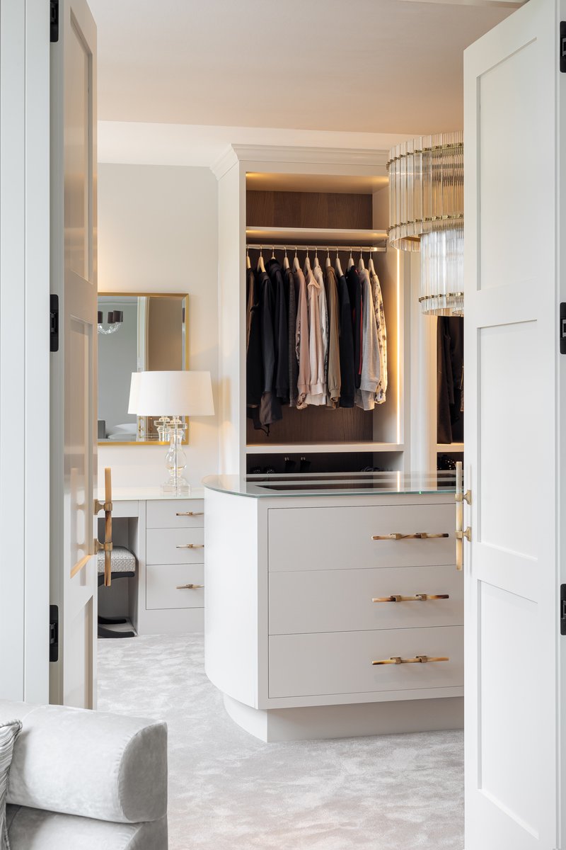 Disguised wardrobe doors in this luxurious bespoke bedroom design lead to the sophisticated dressing room beyond. #bespokebedrooms #bedroomfurniture #handmadebedrooms #bedroomdesign #bedroomdesigns #dressingroomdesign #dressingroomfurniture #ultimatedressingrooms