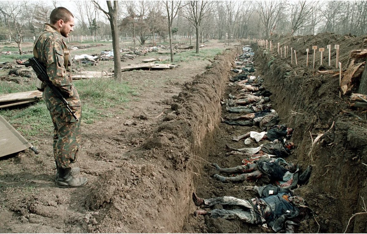 Russian Army soldier with the bodies of Chechen civilians killed during battles, in Grozny, Chechnya, March 31, 1995

We never learn from history.