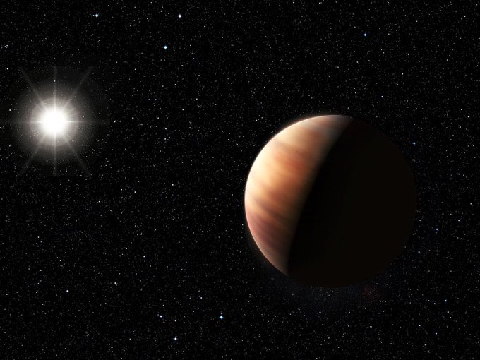 An artist’s impression showing a newly discovered Jupiter twin gas giant orbiting the solar twin star, HIP 11915. The planet is of a very similar mass to Jupiter and orbits at the same distance from its star as Jupiter does from the Sun. In the foreground, the planet is orange and half in shadow. Around it is space with many stars. In the background there is a larger, brighter star that is the sun.