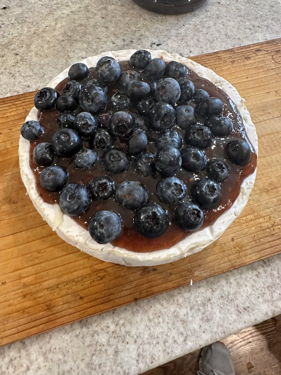 gmorton512's tweet photo. A family favorite appetizer for tonight.  Brie cheese topped with raspberry chipotle sauce, blueberries, toasted almonds and pine nuts.  Will heat on #biggreenegg #bigreenegg until cheese softened significantly. https://t.co/KM2Ph03wJJ