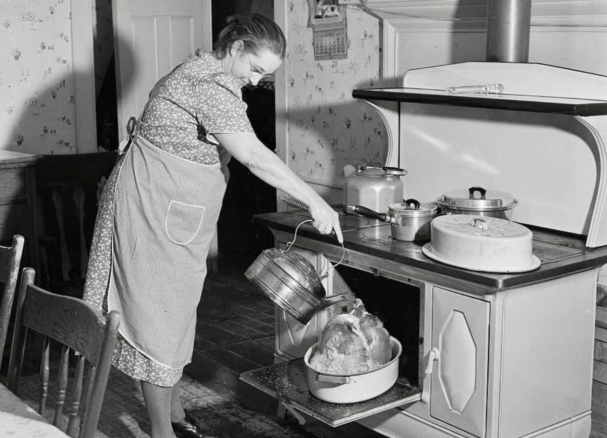 Mrs. Crouch pouring some water over her twenty-pound turkey on Thanksgiving Day. Ledyard, Connecticut in 1940.