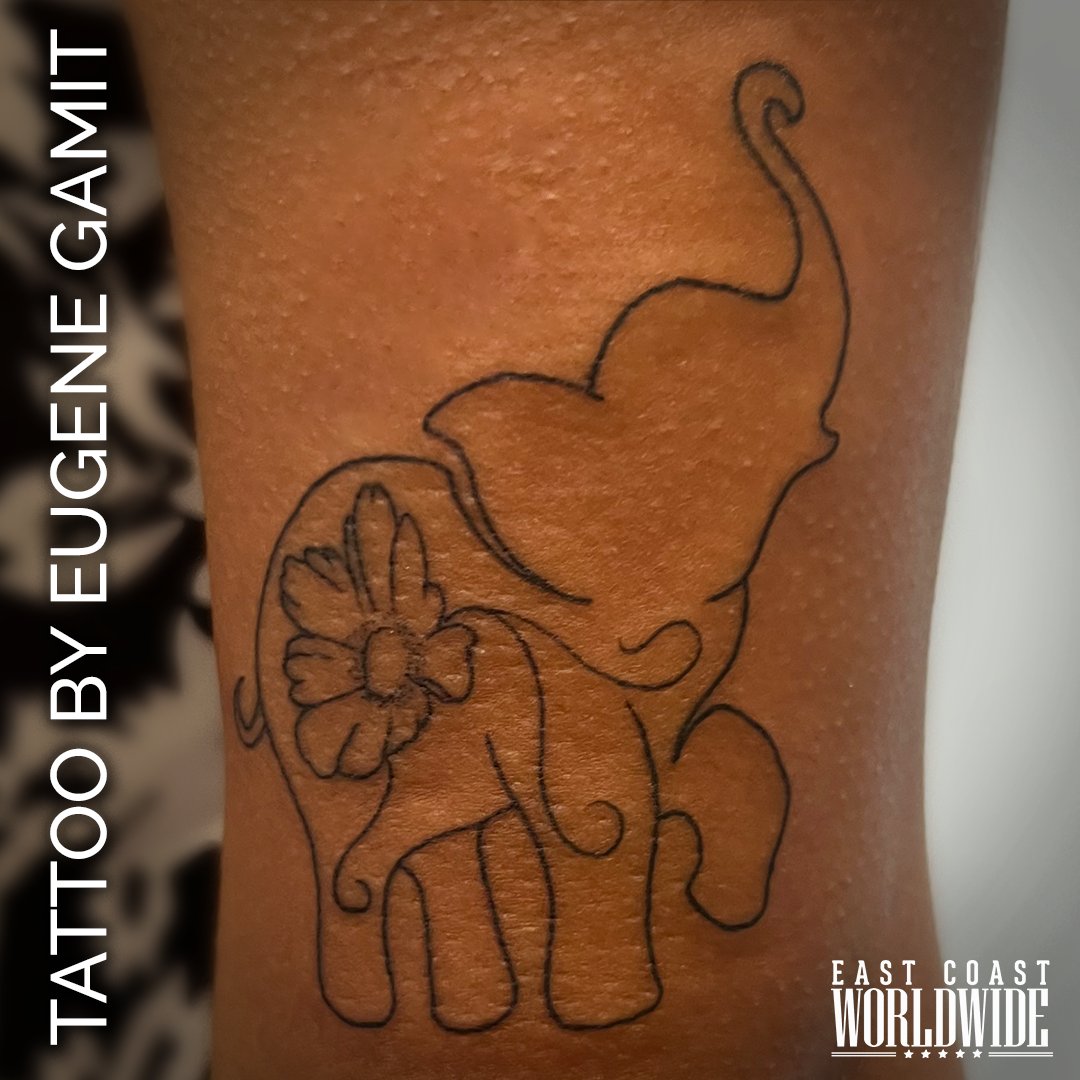 A cute, delicate tattoo outline of an elephant with a flower on its back, created by Eugene Gamit!  #delicatetattoo #elephant #savetheelephants #flowerstyle #created #tattoo #jacksonville #northeastflorida #tattooideas #tattoooftheday #tattooinspo #Jacksonvilletattoos #ECW