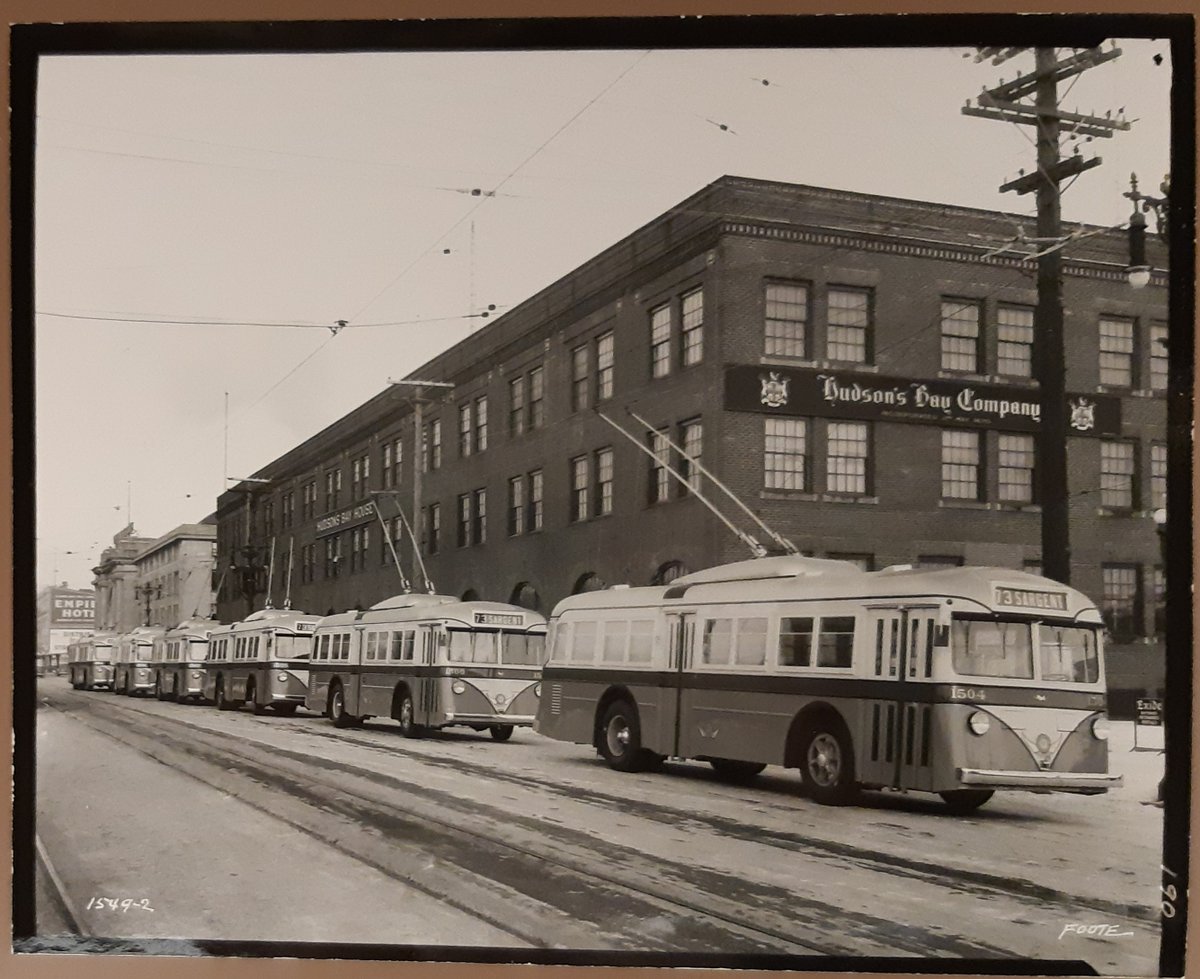 Trolley buses lined up in front of Hudson's Bay House which was located at 79 Main Street, Winnipeg, in November 1938. This photo is by L. B. Foote. #WinnipegHistory bit.ly/3GySW8t