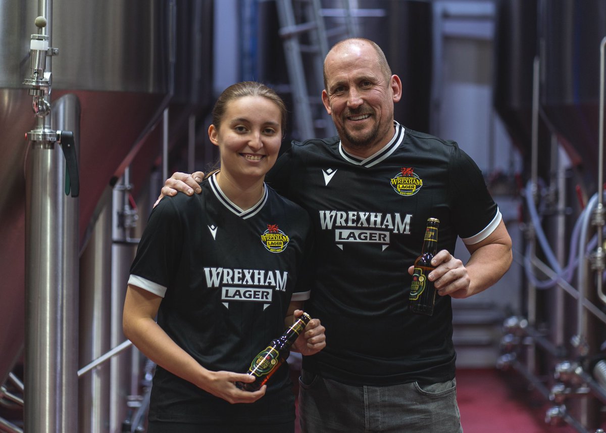 Our Black Shirts have just landed back in stock, and we couldn't have picked a better pair to show how great they look 🤝 Like father, like daughter with Neil & Mia Roberts. Get yours: wrexhamlager.co.uk/shop/wrexham-l…