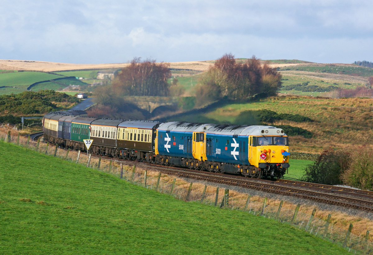 McateeTom's tweet photo. Fifty Friday… 😅 50031 'Hood’ &amp; 50049 'Defiance' turn on the power through the steep 'S' bend climb East of Clapham on the Little North Western route with the 'Airean Raider' Cardiff to Leeds tour. 16th Dec 2006. 📸 ☀️ @FiftyFund 

🎅➡️🏞🚂 https://t.co/ofSLbULaGy https://t.co/rtRAtcARj6