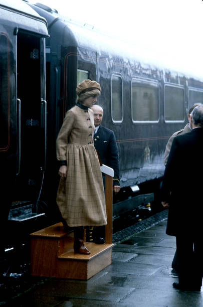 25th November 1982: Princess Diana, visiting West Wales, Arriving at Aberdyfi Station, Diana's coat dress is made of tan coloured checked wool with brown leather cuffs and collar and was designed by designer Arabella Pollen.

📸 by John Shelley Collection/Avalon/Getty Images