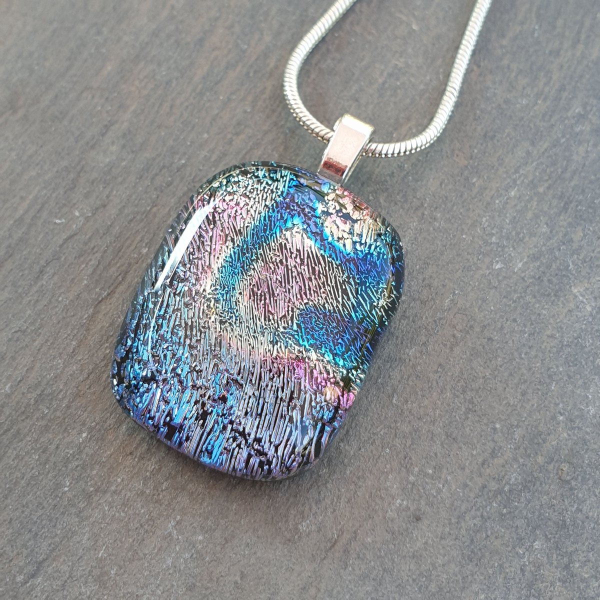 Beautiful shimmering colours within this unique handcrafted dichroic glass necklace. Lovely handcrafted pendant. #handmade #jewellery #etsy #shopindie #giftideas buff.ly/3sBwBmI