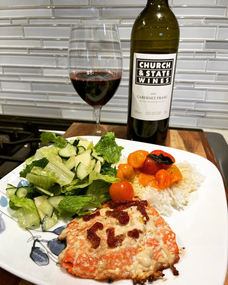 Enjoying @churchandstatewines cab franc with grilled sockeye sun dried tomatoes and basil sungold sakura tomatoes and green salad ambrosia apples cucumber #homecooking #foodandwine #bcwine #wine #food #sungoldtomatoes