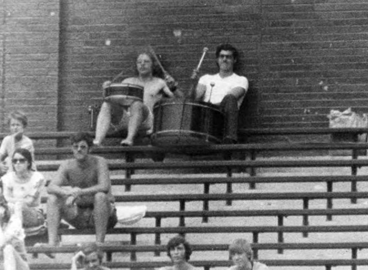 EncyCle_'s tweet photo. The heartbeat of tribe baseball John Adams (right) and friend drumming in the bleachers at #Cleveland Municipal Stadium in 1973. Credit: @Cleve_Memory  

#CleStartsHere #cwru #ThisIscle #ohio #cle #ThisWasCle @CleGuardians #Fortheland https://t.co/HFJzp8zdtp