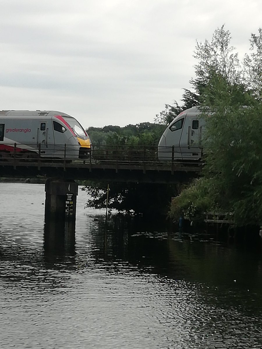author_king's tweet photo. Enjoying a drink by the river when these trains stopped on the bridge. Both drivers got out, chatted for a couple of minutes then they carried on with their journeys! https://t.co/KVxzoyGEkG