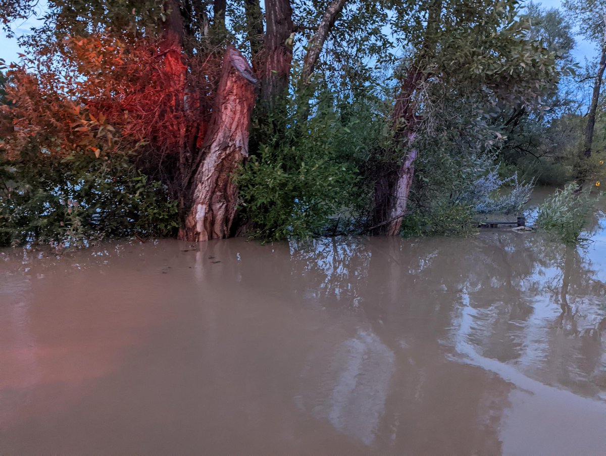 NMDOT's tweet photo. N.M. 240 outside of Taos. The road is closed due to flooding after very heavy rains–water is almost 4 feet deep in some spots of the road. Photography by the Joseph Mondragon, Supervisor for the Taos Patrol. #TurnAroundDon'tDrown #DistrictFive https://t.co/ayUthMRLCz