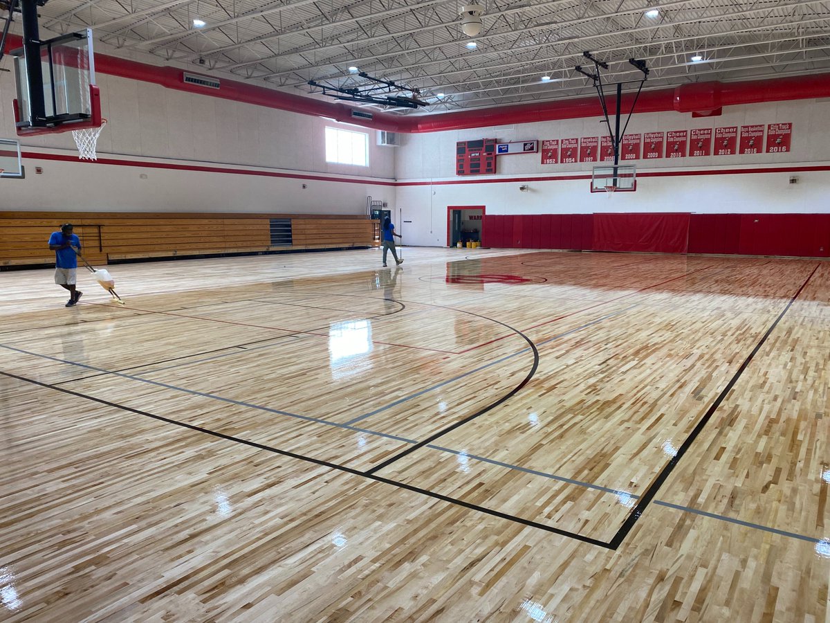 They are applying the final coats of poly to our new gym floor.