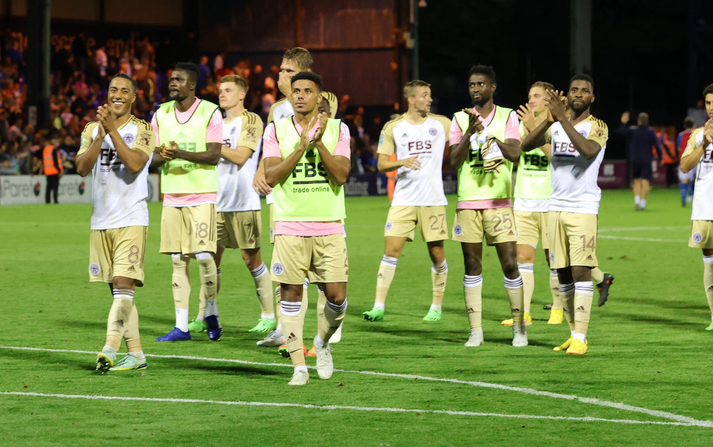 The City players applaud the away supporters following the match.