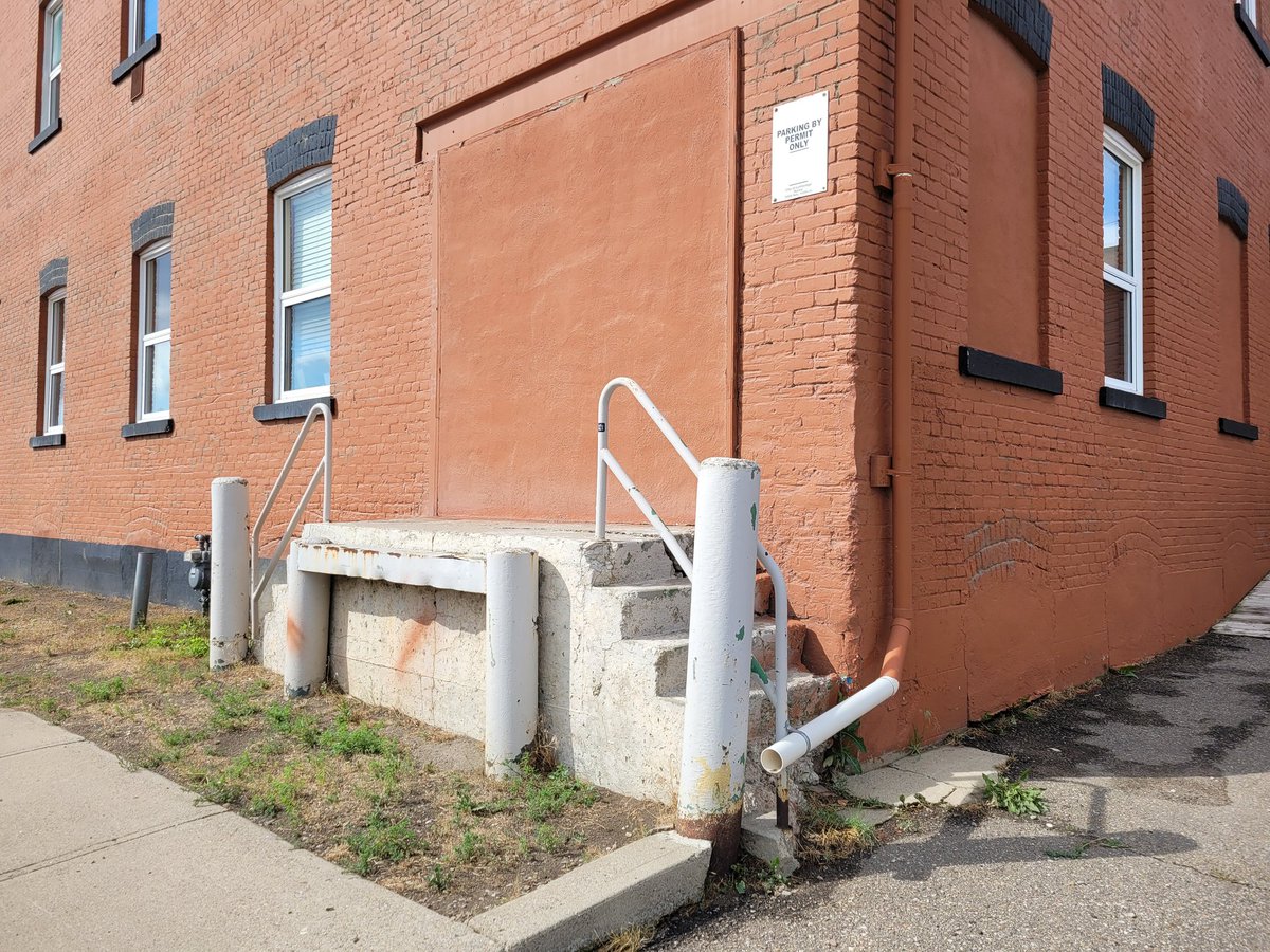 BelindaCrowson's tweet photo. Oh, the things you find when you take a walk, including an amazing chalk mural, covered in windows and doors (that tell the story of the bldg) and a sidewalk stamp I previously missed. #Lethbridge #yql https://t.co/lYOfkfBJYi