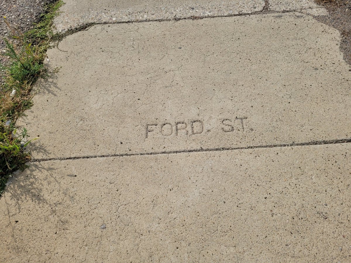 BelindaCrowson's tweet photo. Oh, the things you find when you take a walk, including an amazing chalk mural, covered in windows and doors (that tell the story of the bldg) and a sidewalk stamp I previously missed. #Lethbridge #yql https://t.co/lYOfkfBJYi