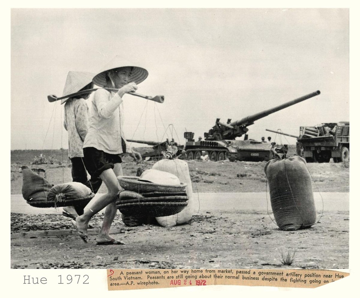 WarsIndo's tweet photo. Villagers walk by two M-107 self propelled 175 mm howitzers near Hue 24 August 1972; the "one-seven-fives' could fire a shell 25 miles #VietnamWar #EasterOffensive https://t.co/8U9uJ0VKDt