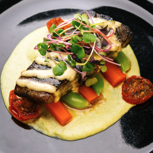Our blackened Atlantic halibut is making waves, with sauteed carrots, snap peas, oven roasted cherry tomatoes, smoked jalapeno aioli &amp; pea puree. Stop in for dinner tonight and try it for yourself.