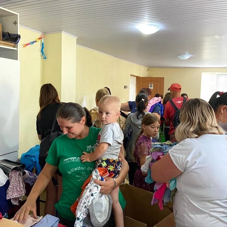 IATonline's tweet photo. Ukrainian refugees in Moldova have been very grateful for the welcome and support from local people, and for the aid you have donated. Pictures show families selecting clothes and bedding spread out in the church hall and Pastor Victor sorting through boxes #christiancompassion https://t.co/ailVjPYbn3
