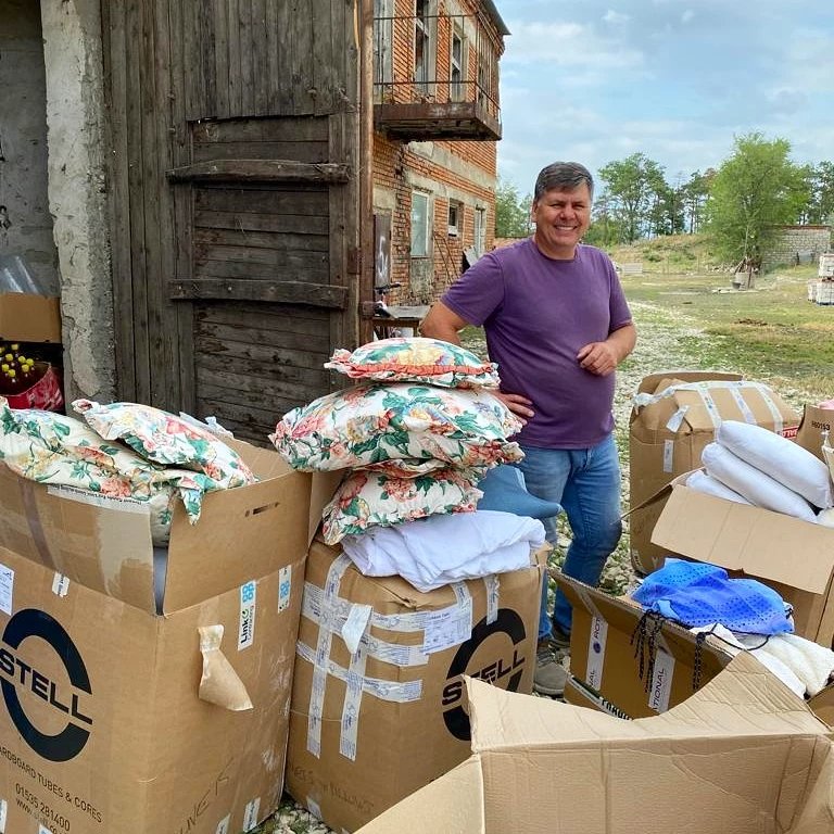 IATonline's tweet photo. Ukrainian refugees in Moldova have been very grateful for the welcome and support from local people, and for the aid you have donated. Pictures show families selecting clothes and bedding spread out in the church hall and Pastor Victor sorting through boxes #christiancompassion https://t.co/ailVjPYbn3