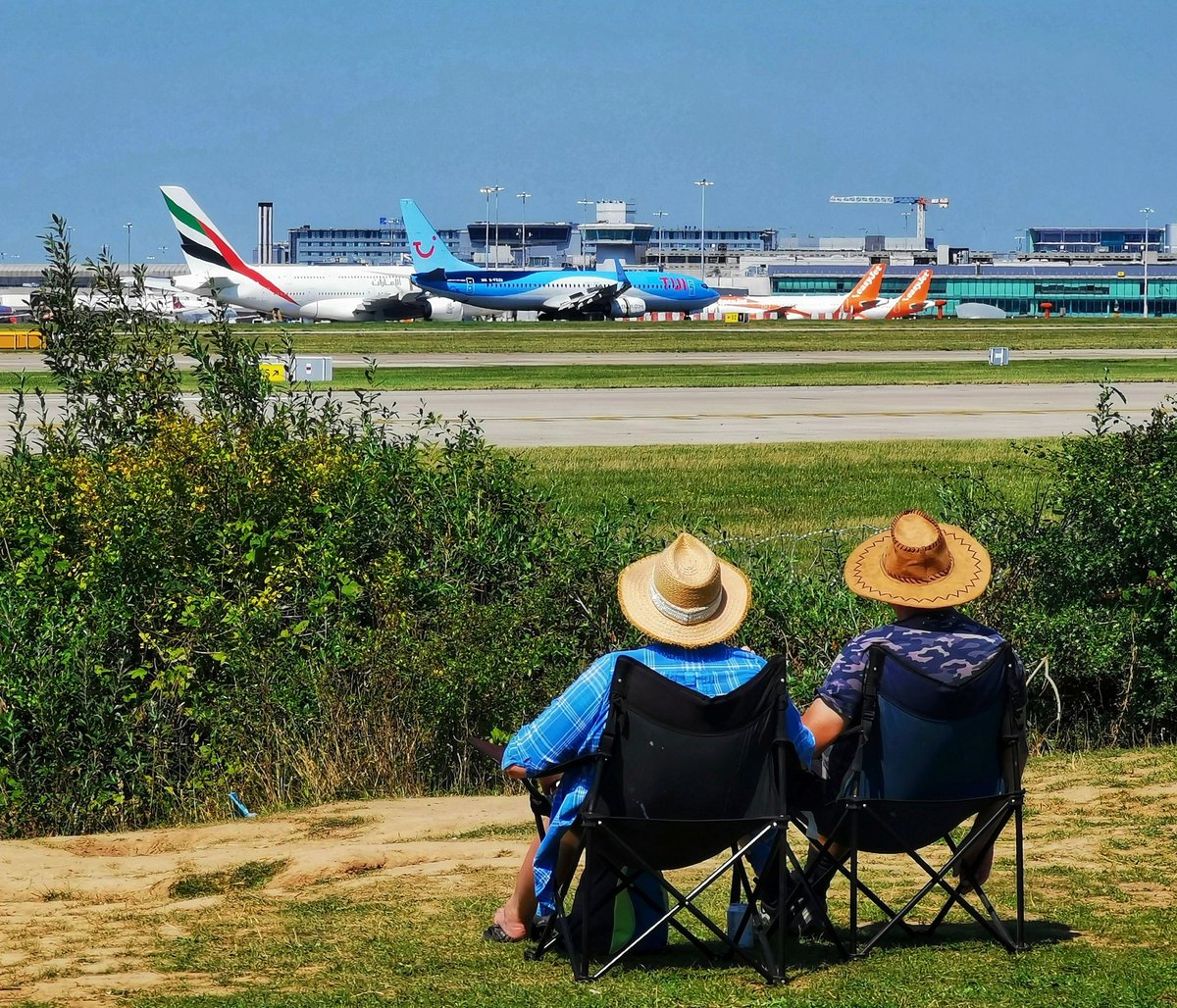 Plane spotters at Manchester airport in 30 degree heat. (All rights reserved)